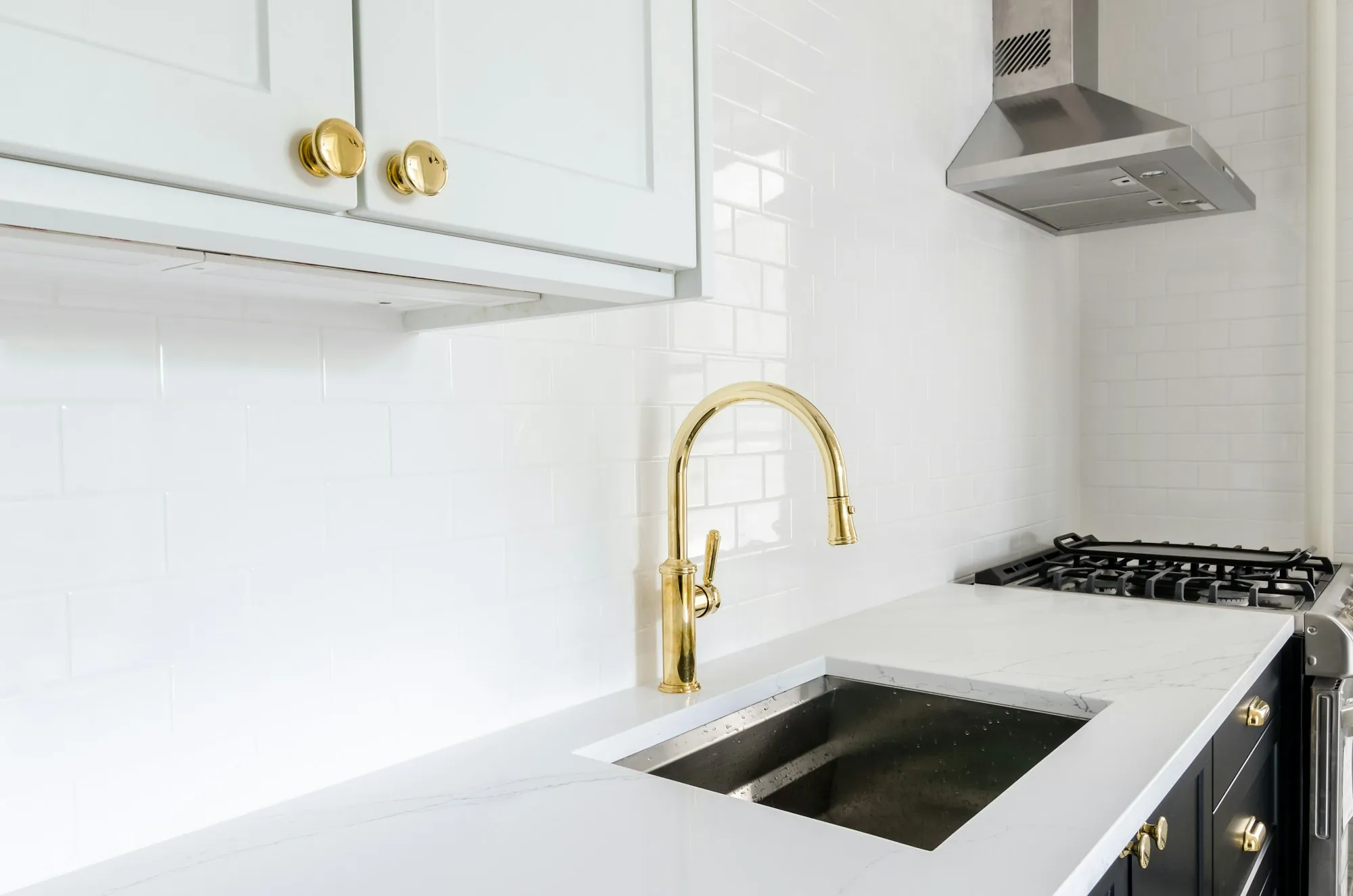 Bright kitchen with a gold faucet