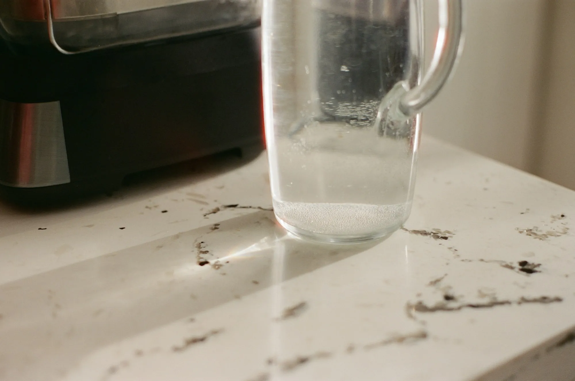 Glass pitcher of water on a kitchen counter