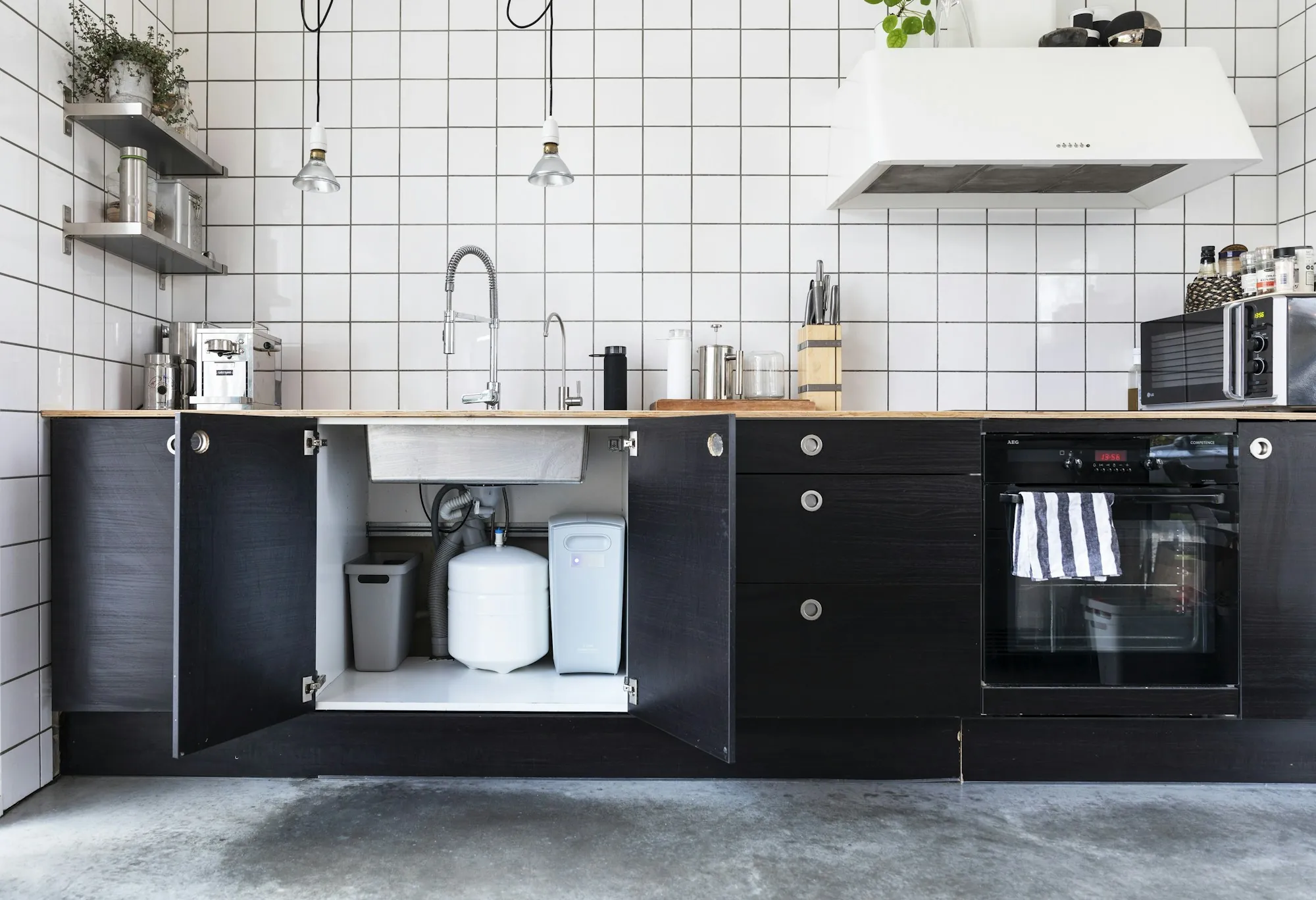 Kitchen with dark cabinets and a filtered water faucet